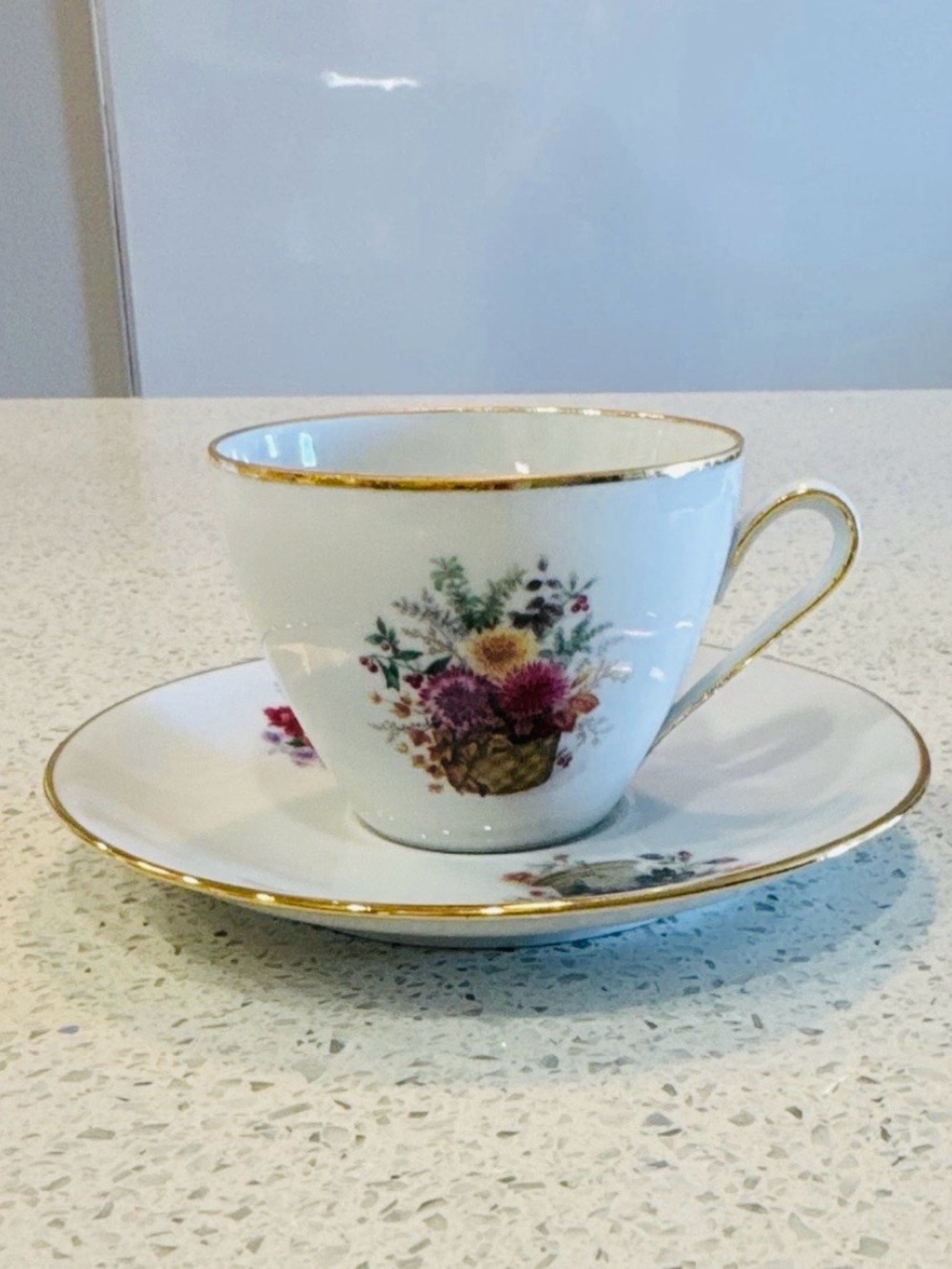 Kuba Vintage White Porcelain Teacup and Saucer with Gold Trim and Floral Basket